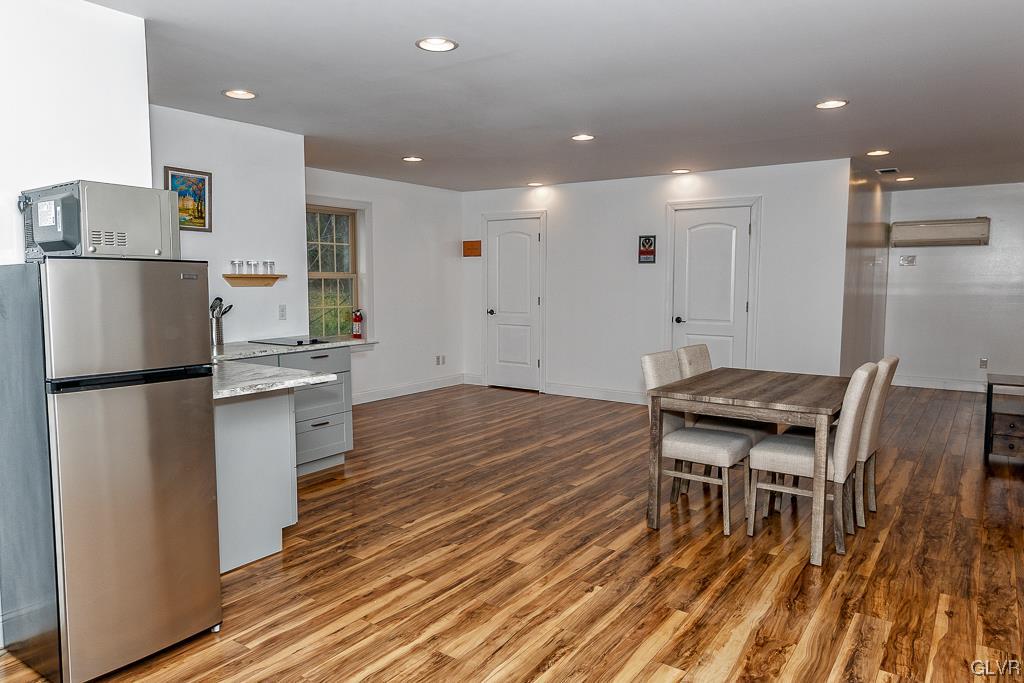 973 Renaldi Road Wind Gap, PA 18091 - Photo 45 of 50 a kitchen with stainless steel appliances refrigerator wooden floor and dining table