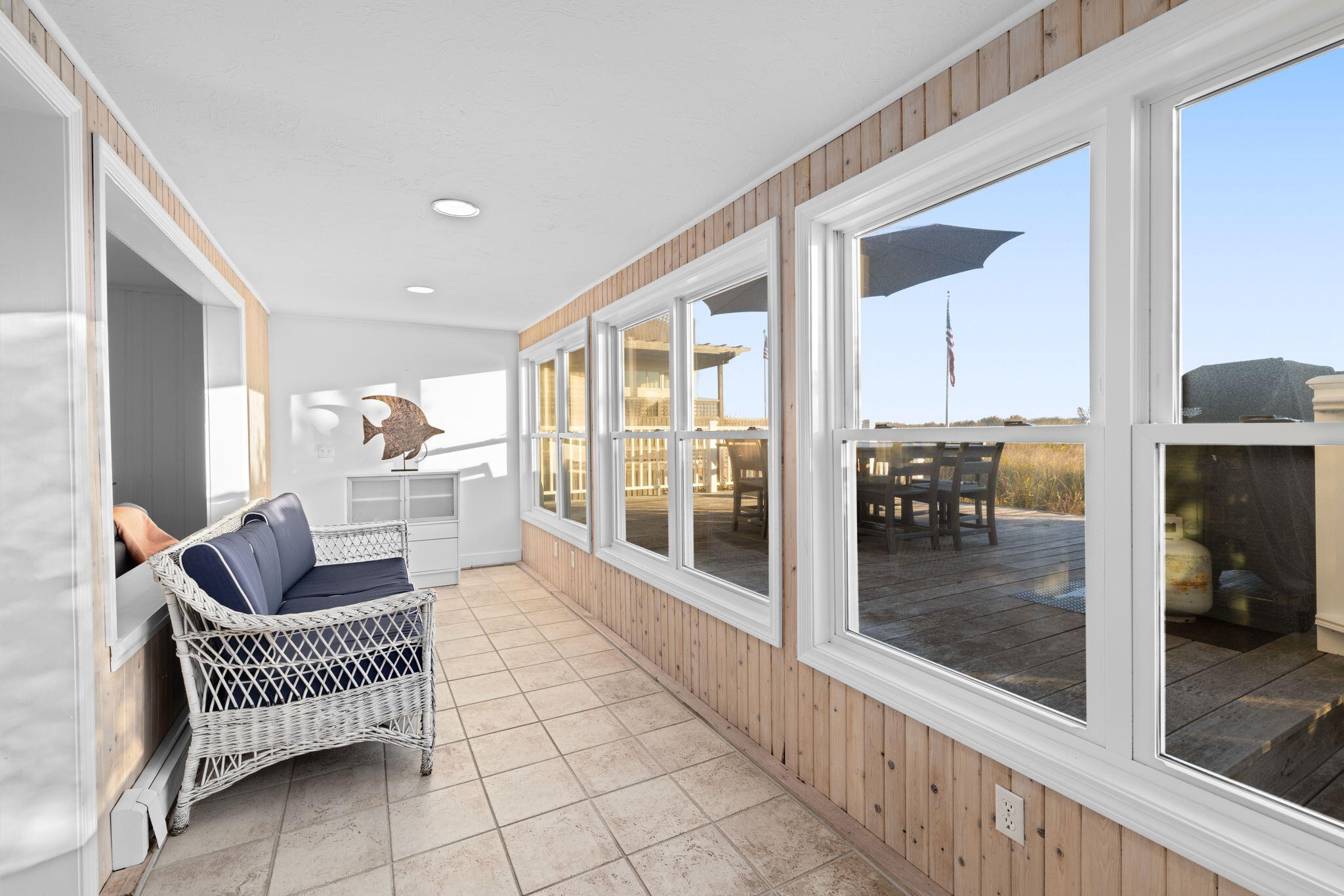 133 Phillips Road Sagamore Beach, MA 02562 - Photo 14 of 45 a living room with furniture and a floor to ceiling window