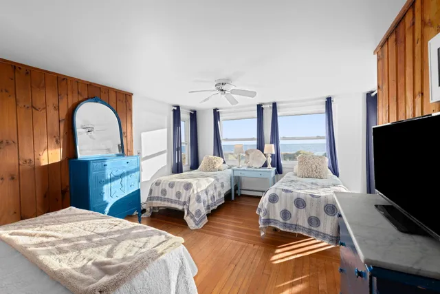 a bedroom with two beds and a flat screen tv