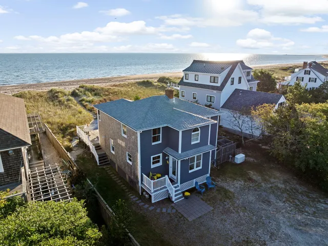 an aerial view of residential houses with outdoor space