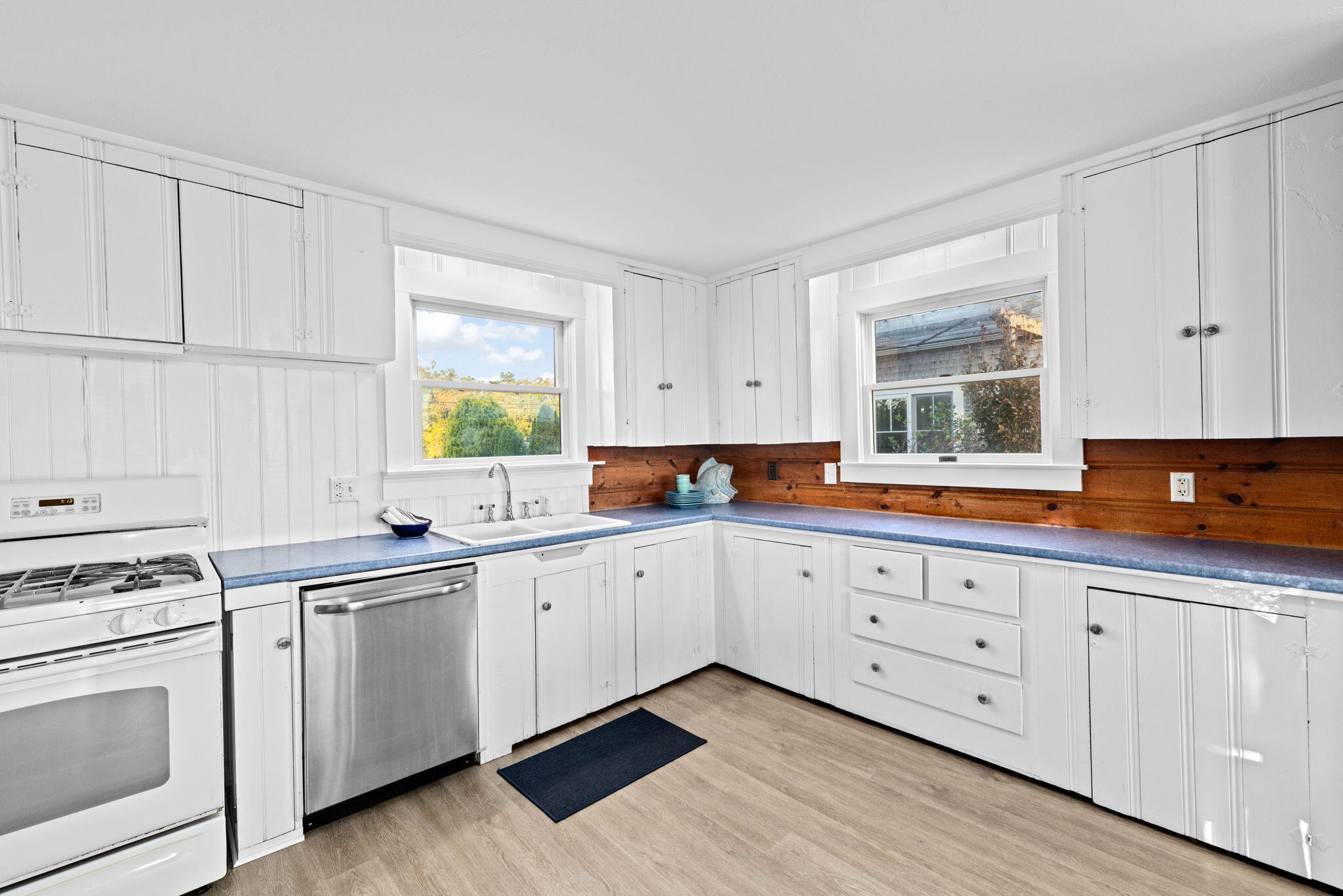 133 Phillips Road Sagamore Beach, MA 02562 - Photo 8 of 45 a kitchen with granite countertop white cabinets sink and appliances