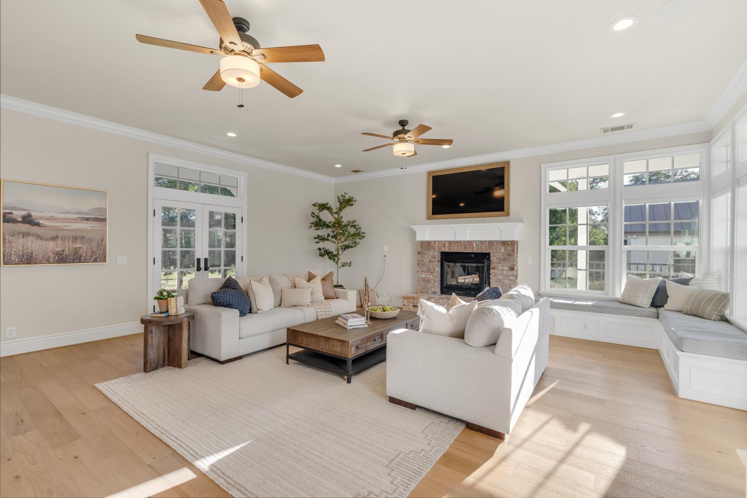 2905 Virginiatown Road Lincoln, CA 95648 - Photo 19 of 86 Spacious living area featuring light wood-finish flooring, a brick-surround fireplace with a white mantel, and a built-in window bench