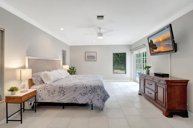 a bedroom with a large bed and a chandelier