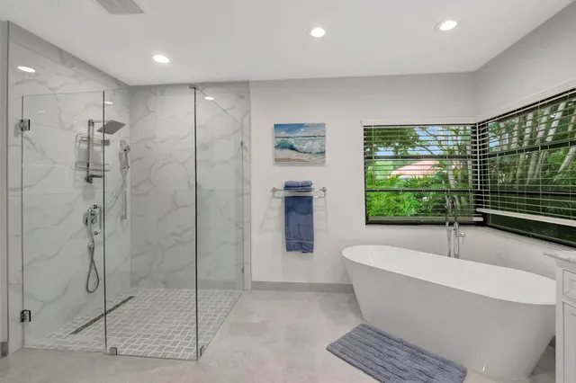a bathroom with a glass shower door
