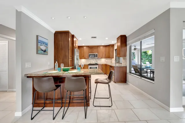 a view of a dining room with furniture large windows and wooden floor