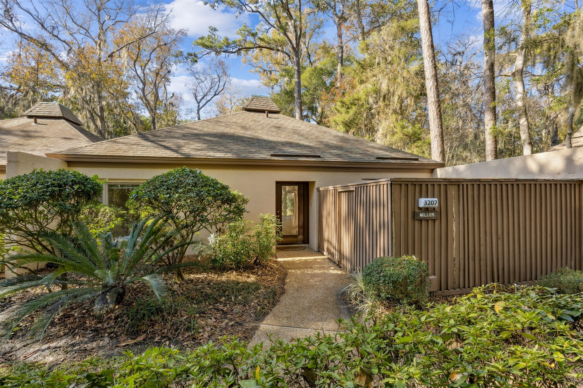 3207 Sea Marsh Road Fernandina Beach, FL 32034 - Photo 1 of 37 a front view of a house with garden