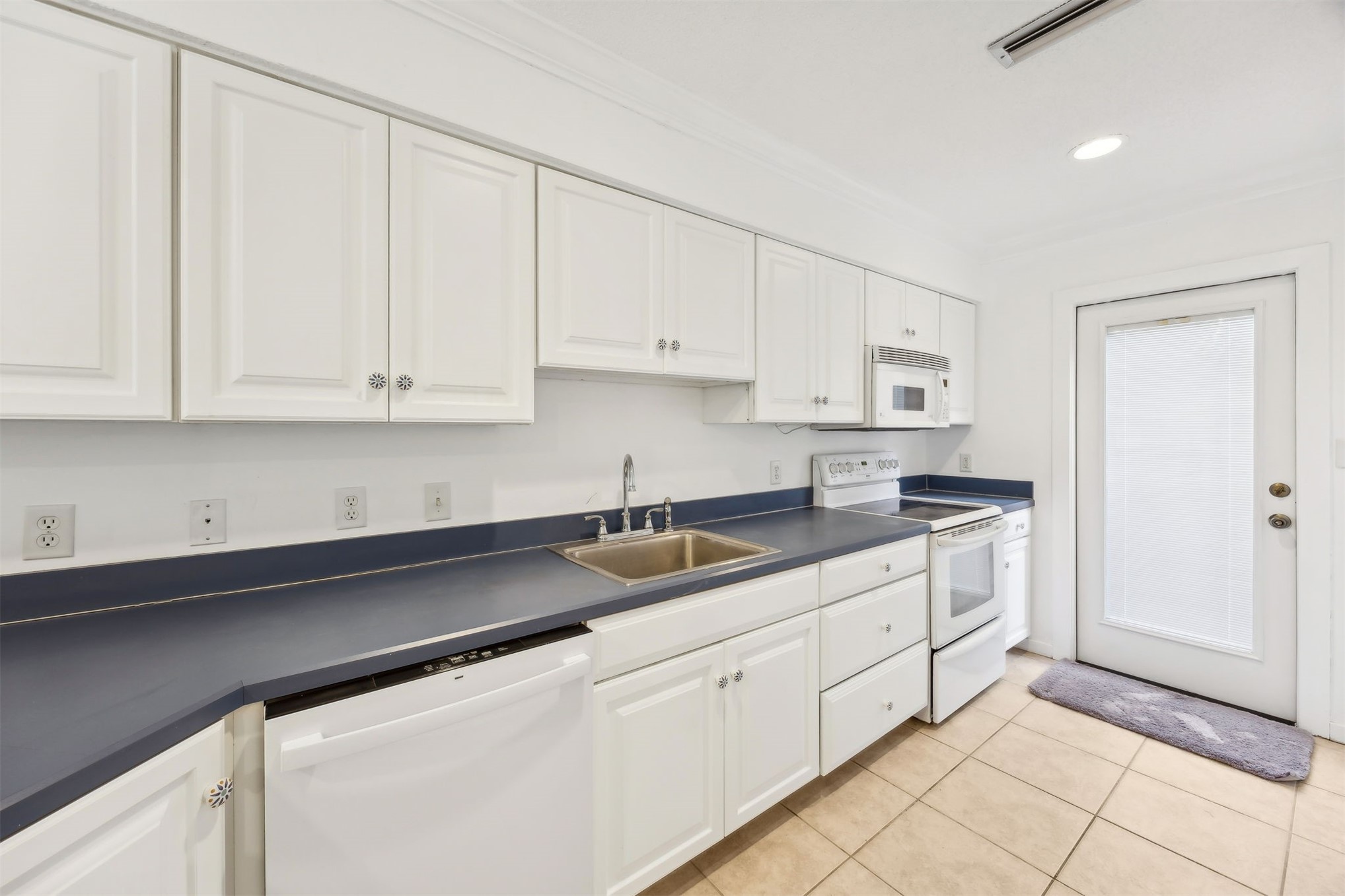 3207 Sea Marsh Road Fernandina Beach, FL 32034 - Photo 11 of 37 a kitchen with granite countertop white cabinets and sink
