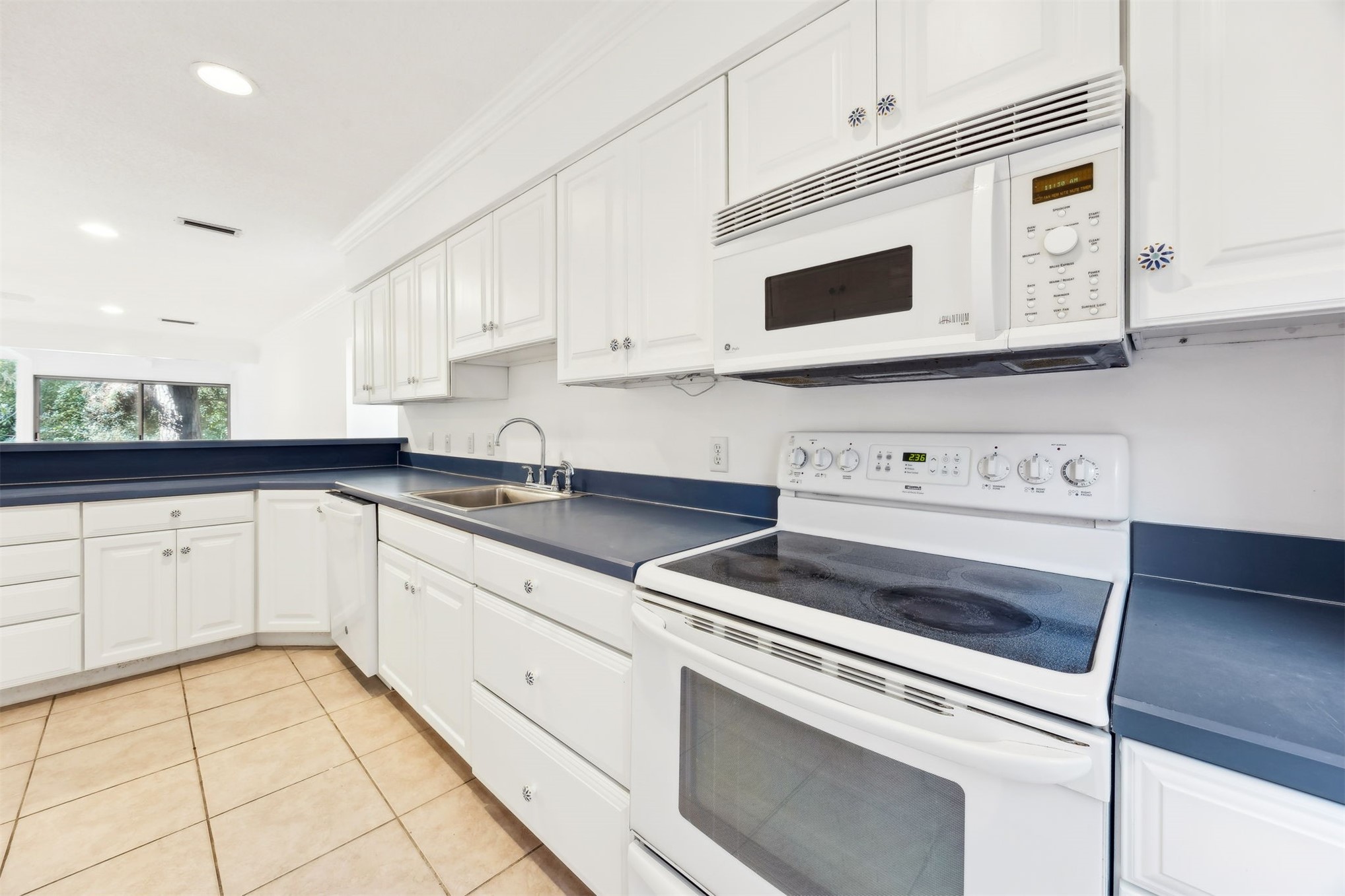 3207 Sea Marsh Road Fernandina Beach, FL 32034 - Photo 13 of 37 a kitchen with granite countertop white cabinets and white appliances