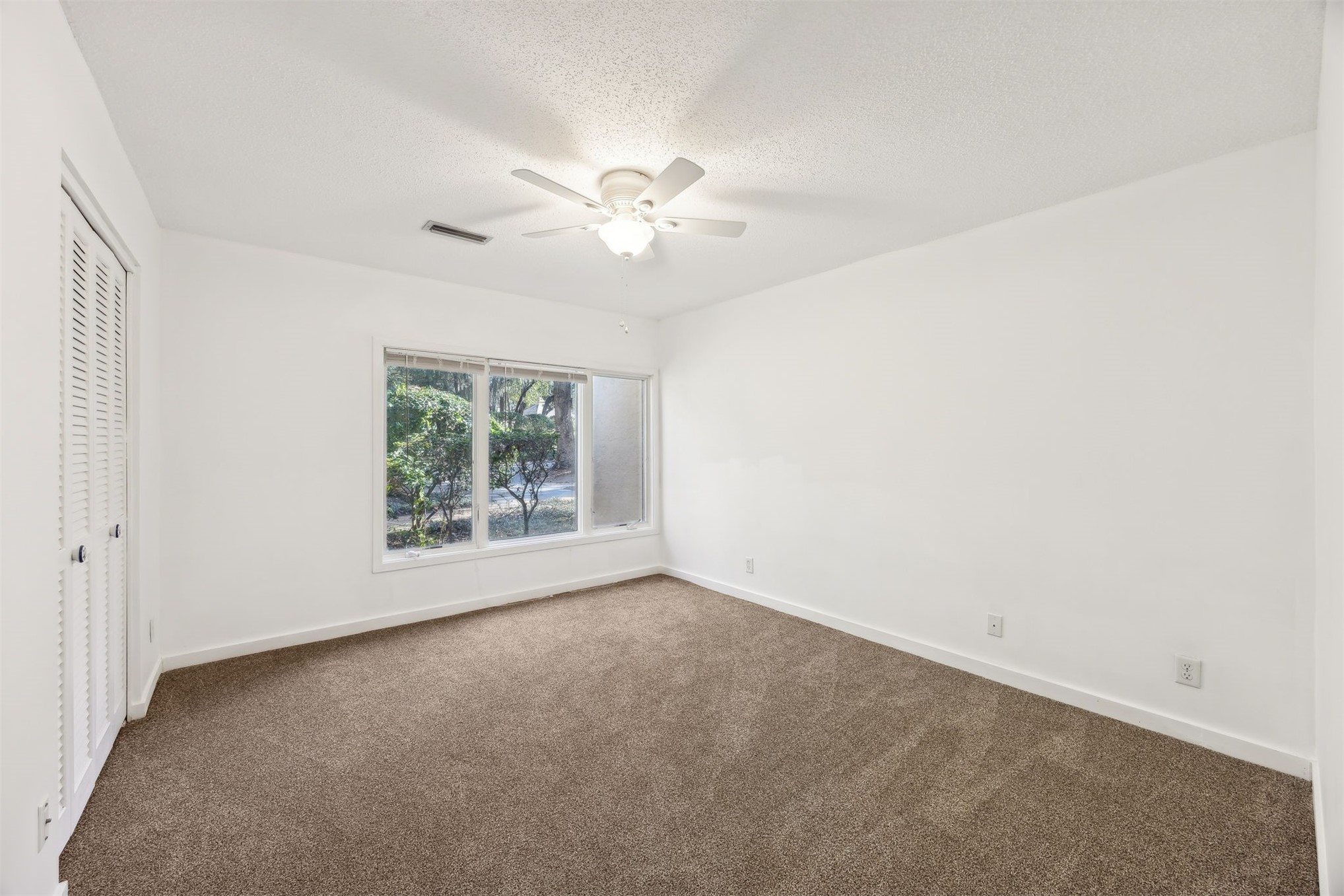 3207 Sea Marsh Road Fernandina Beach, FL 32034 - Photo 21 of 37 an empty room with a window and a fan