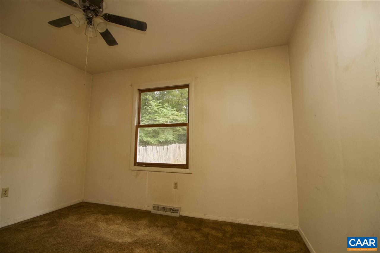 495 Lake Road Troy, VA 22974 - Photo 8 of 10 an empty room with a window and a fan