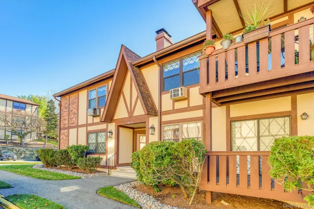 a front view of a residential apartment building with a yard