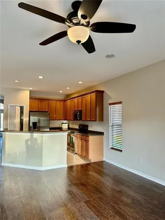 a kitchen with stainless steel appliances granite countertop a stove a microwave and a refrigerator