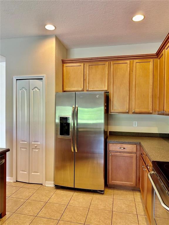 9249 Edistro Place New Port Richey, FL 34654 - Photo 15 of 82 a kitchen with stainless steel appliances granite countertop a refrigerator and a sink