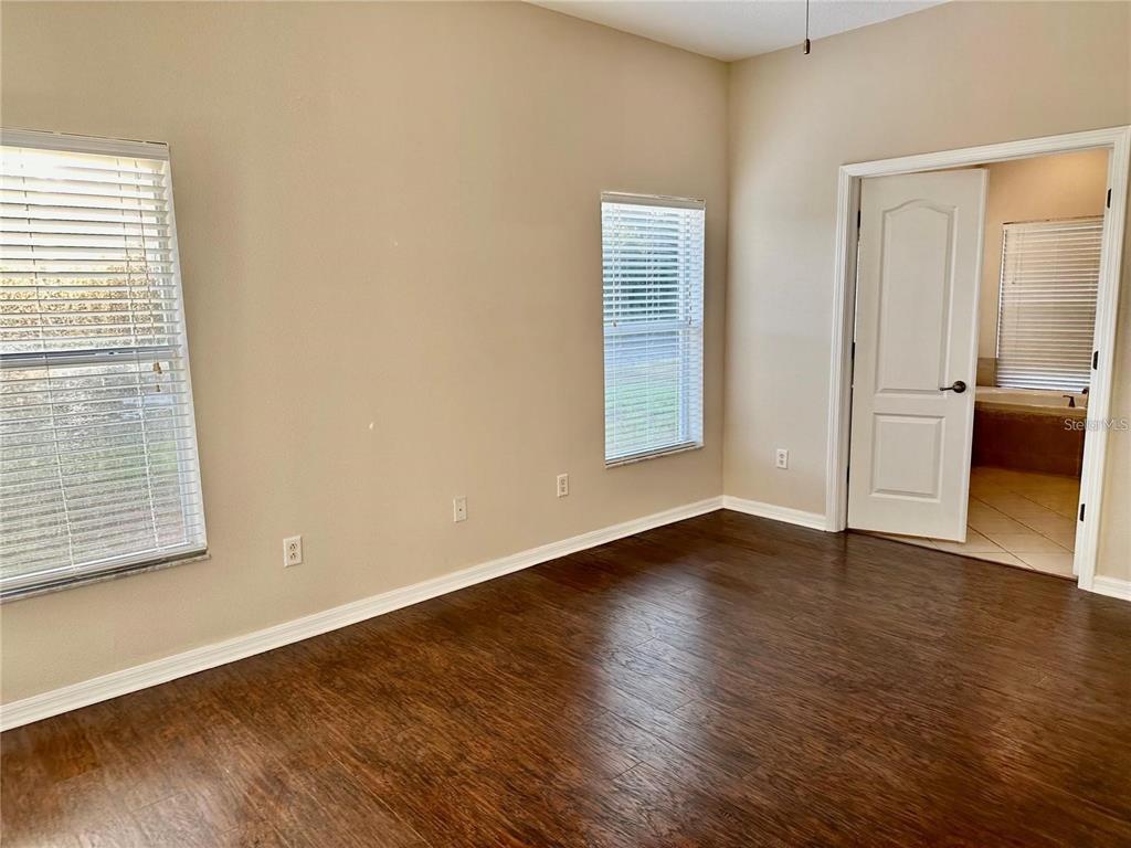 9249 Edistro Place New Port Richey, FL 34654 - Photo 22 of 82 an empty room with wooden floor and windows