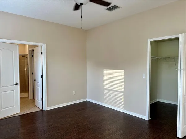 a spacious bathroom with a sink and a mirror
