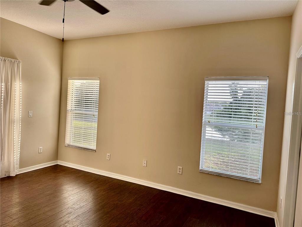 9249 Edistro Place New Port Richey, FL 34654 - Photo 28 of 82 a view of an empty room with wooden floor and a window