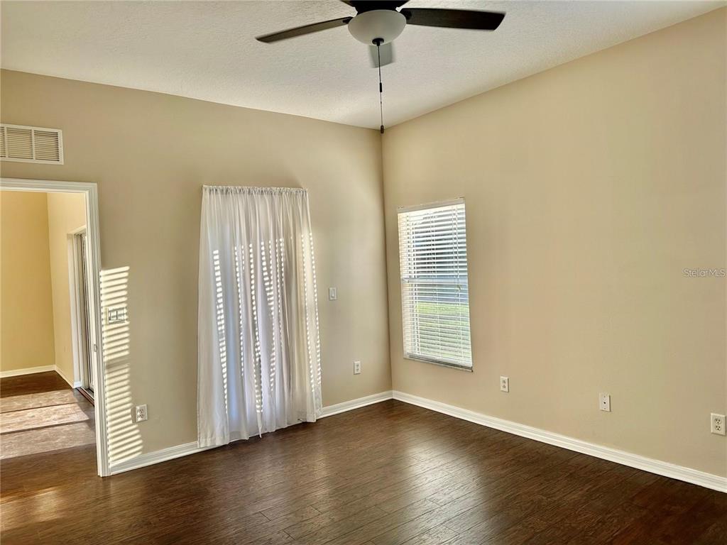 9249 Edistro Place New Port Richey, FL 34654 - Photo 29 of 82 a view of an empty room with wooden floor and a window