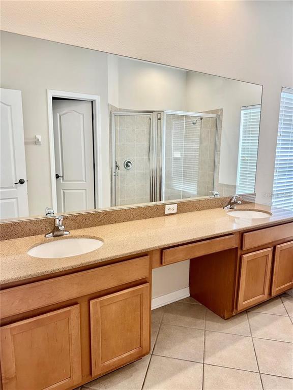 9249 Edistro Place New Port Richey, FL 34654 - Photo 32 of 82 a spacious bathroom with a sink and a mirror