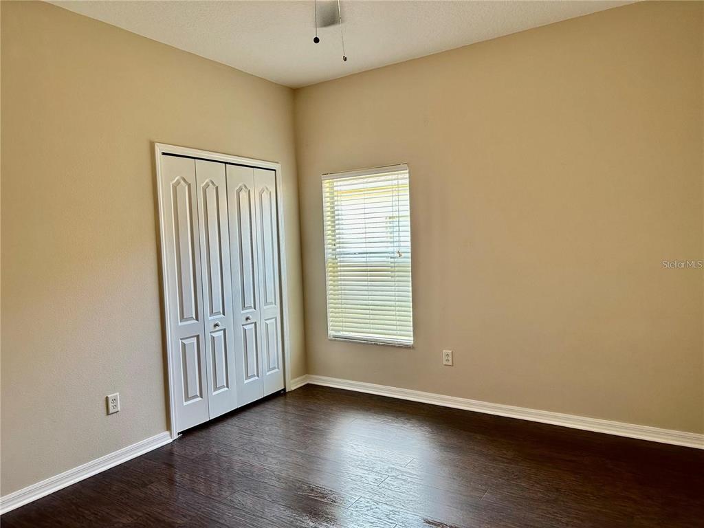 9249 Edistro Place New Port Richey, FL 34654 - Photo 40 of 82 an empty room with wooden floor and windows