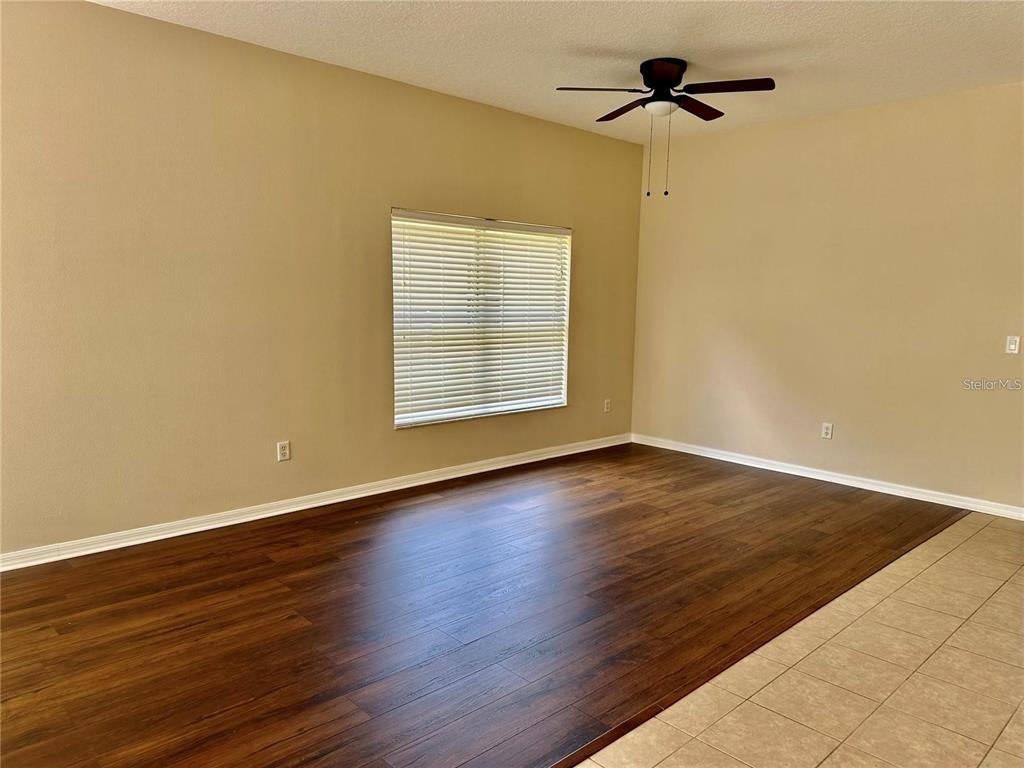 9249 Edistro Place New Port Richey, FL 34654 - Photo 4 of 82 a view of an empty room with wooden floor and a window