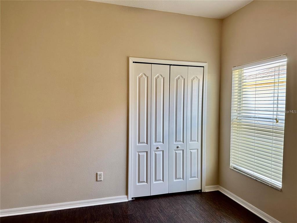 9249 Edistro Place New Port Richey, FL 34654 - Photo 42 of 82 an empty room with wooden floor and windows