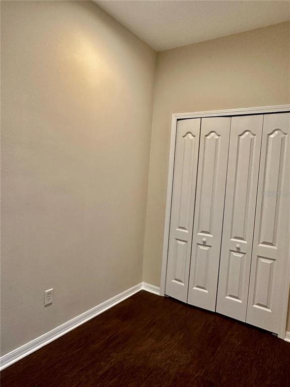 9249 Edistro Place New Port Richey, FL 34654 - Photo 45 of 82 a view of an empty room with wooden floor