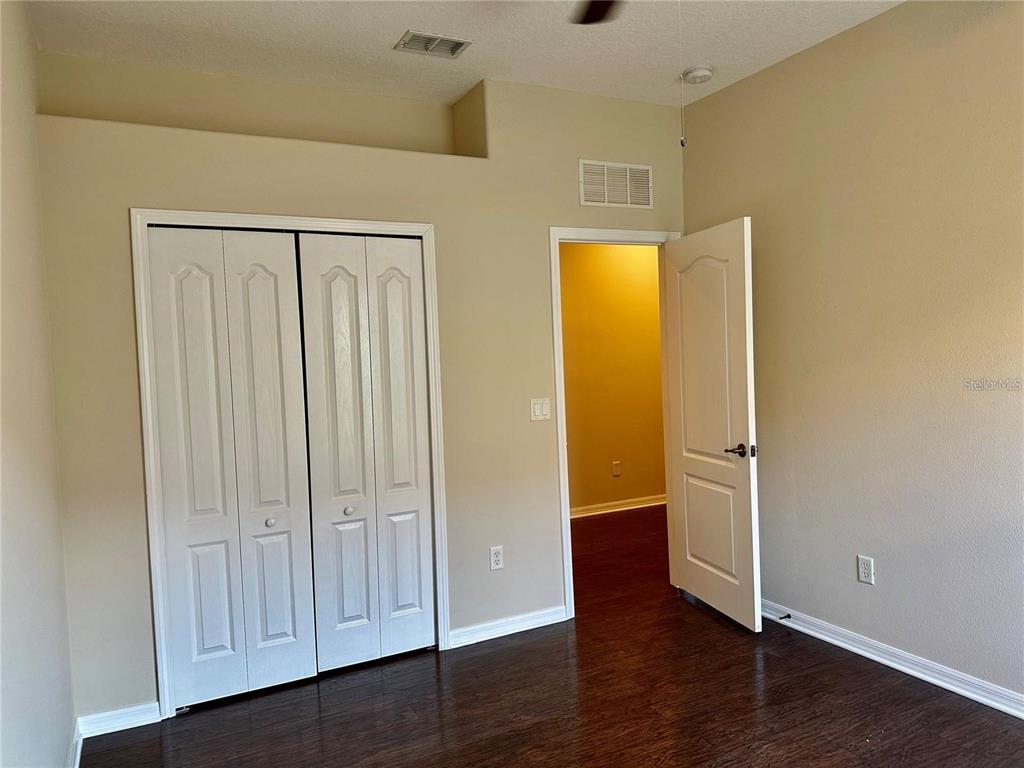 9249 Edistro Place New Port Richey, FL 34654 - Photo 47 of 82 an empty room with wooden floor and closet area