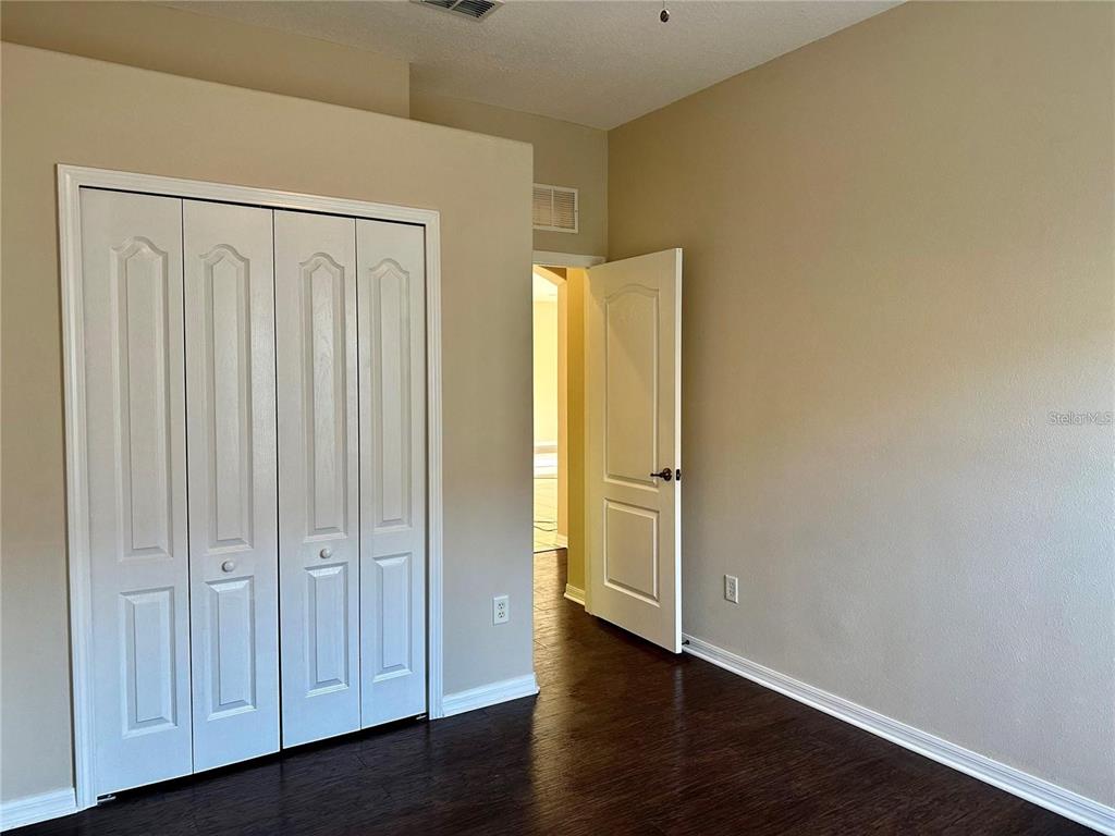 9249 Edistro Place New Port Richey, FL 34654 - Photo 51 of 82 a view of an empty room with wooden floor