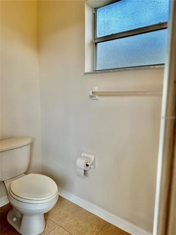 9249 Edistro Place New Port Richey, FL 34654 - Photo 55 of 82 a bathroom with a toilet and a shower