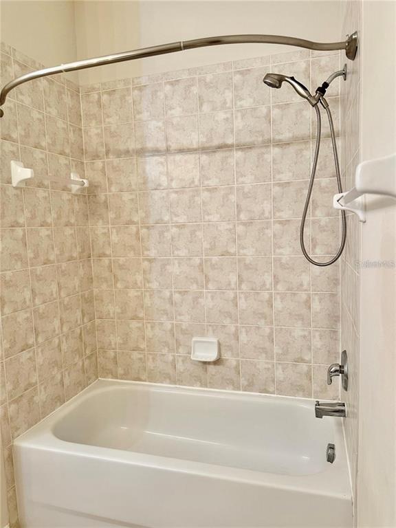 9249 Edistro Place New Port Richey, FL 34654 - Photo 60 of 82 a bathroom with a bath tub and a shower