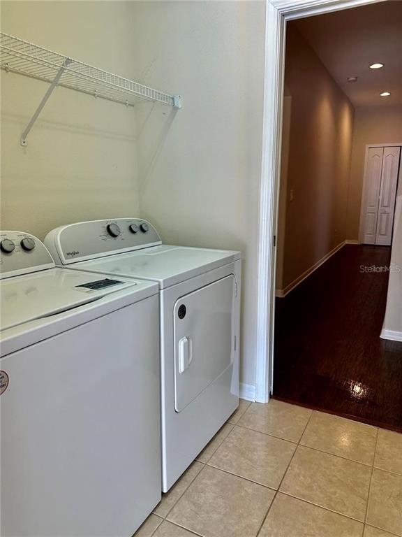9249 Edistro Place New Port Richey, FL 34654 - Photo 64 of 82 a utility room with cabinets washer and dryer
