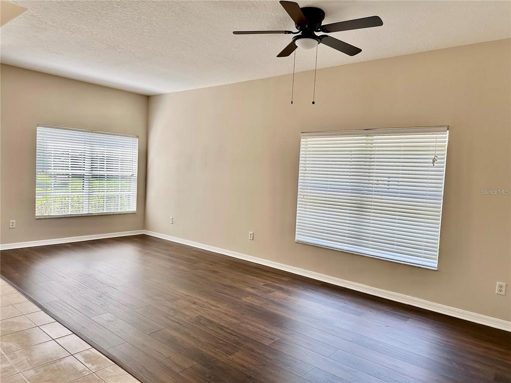 9249 Edistro Place New Port Richey, FL 34654 - Photo 7 of 82 a view of an empty room with wooden floor and a window