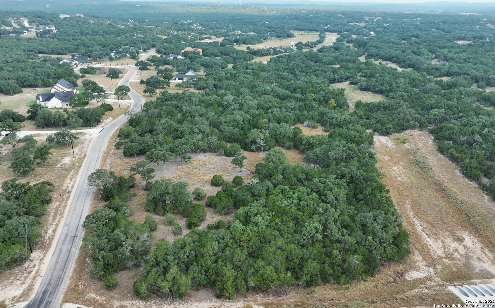 Lot 149 Serenity Pass/ Restless Wind Spring Branch, TX 78070 - Photo 10 of 15 an aerial view of residential houses with outdoor space and trees