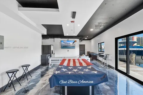 a living room with a flat screen tv and a fireplace