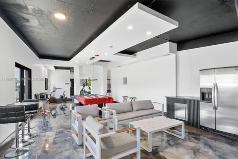 a living room with furniture and kitchen view