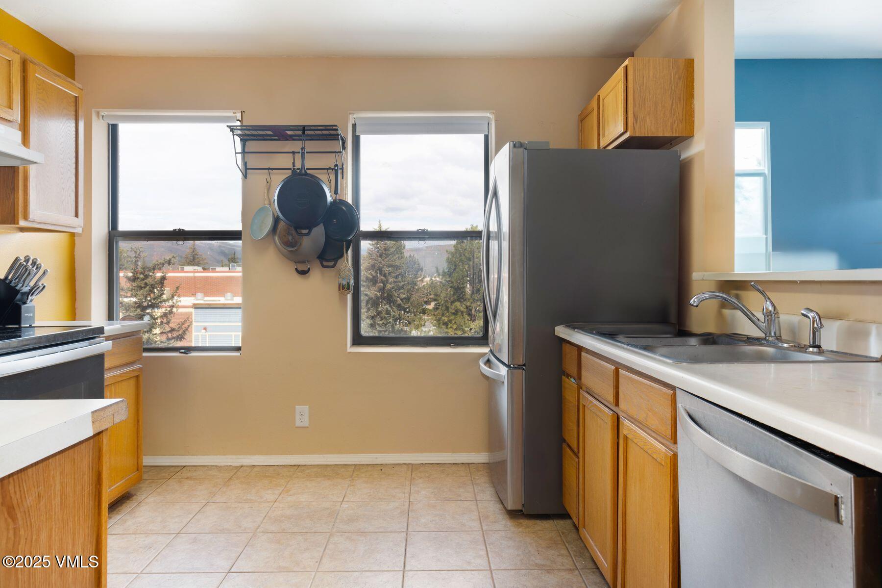 34295 Highway 6, Unit 207 Edwards, CO 81632 - Photo 11 of 23 a kitchen with granite countertop a refrigerator and a sink