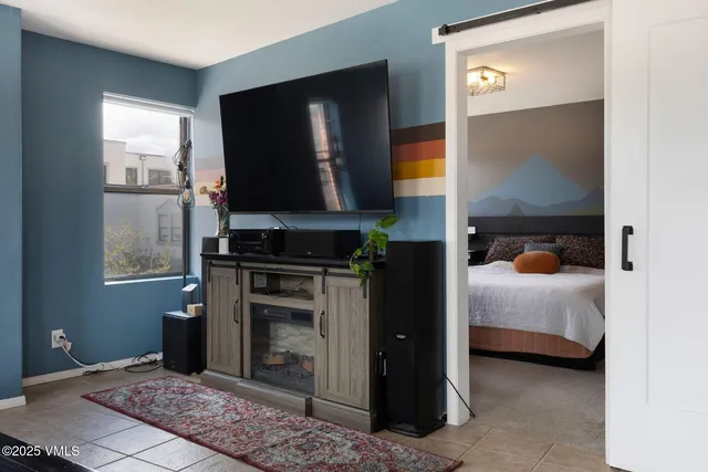 a bedroom with a bed and a television