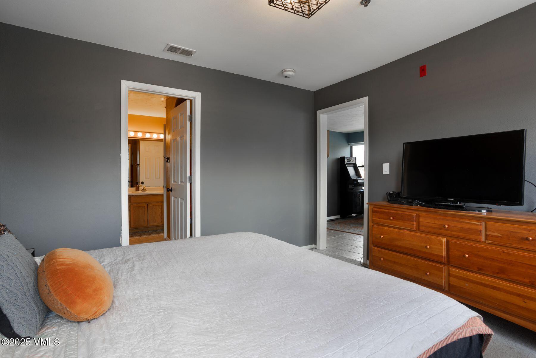 34295 Highway 6, Unit 207 Edwards, CO 81632 - Photo 15 of 23 a bedroom with a bed and a flat screen tv