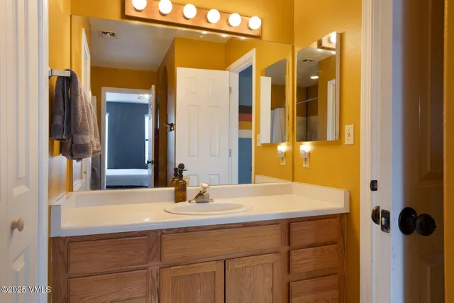 a bathroom with a sink and mirror