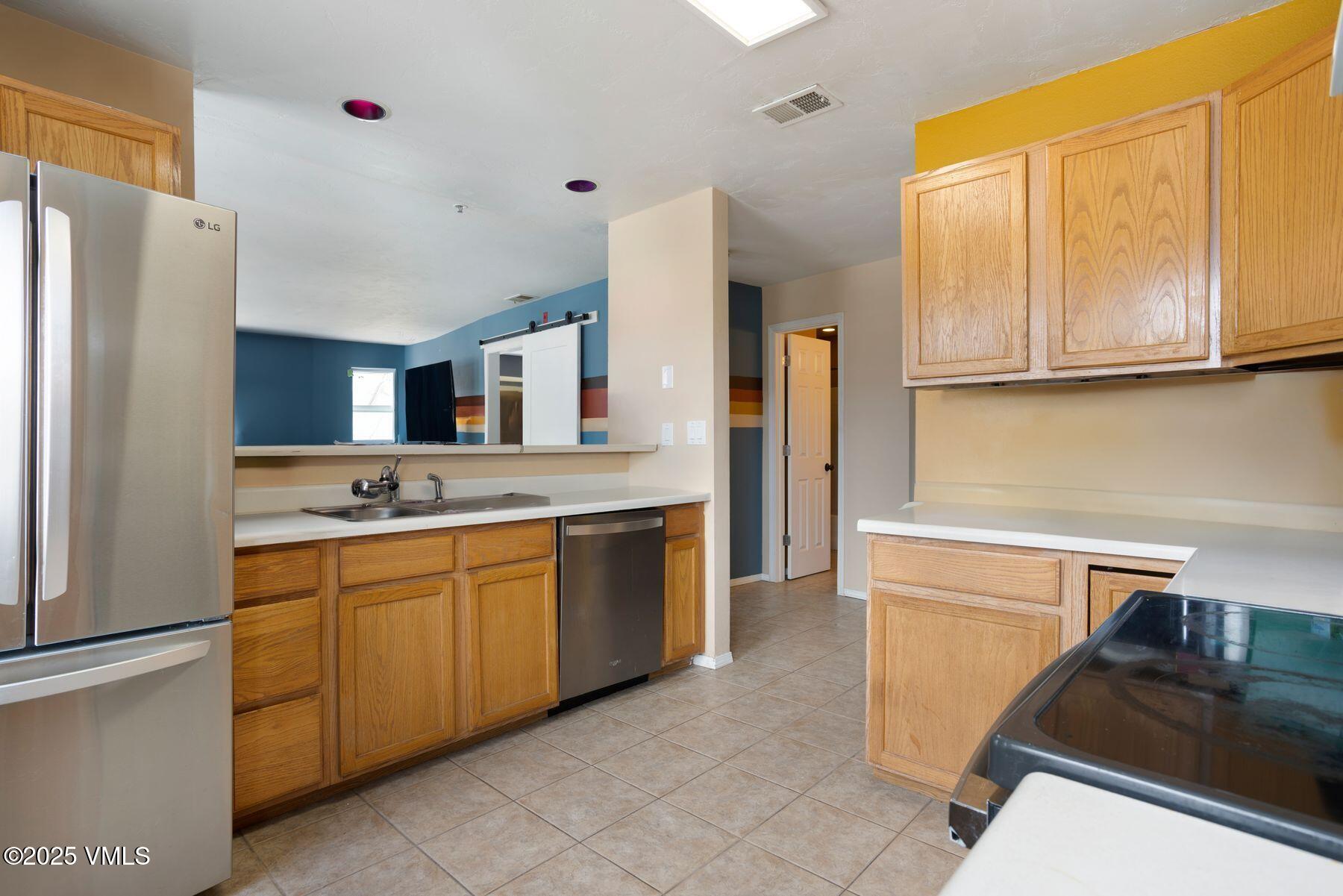 34295 Highway 6, Unit 207 Edwards, CO 81632 - Photo 9 of 23 a kitchen with stainless steel appliances granite countertop a refrigerator and a stove