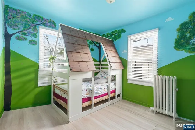 a spacious bedroom with a bed and a window