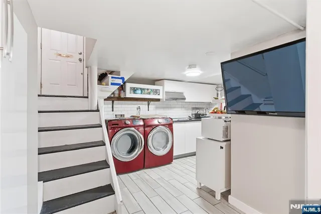 a view of storage and utility room with washer and dryer