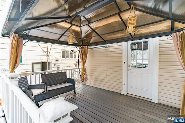a roof deck with couch and wooden floor