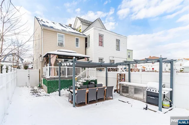 a view of a patio with couches table and chairs and potted plants