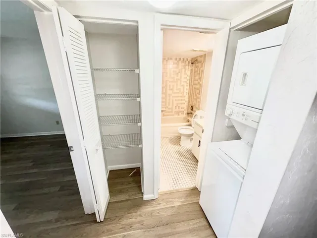 a view of a hallway with wooden floor and entryway