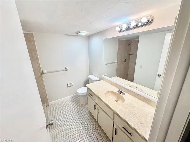 a spacious bathroom with a double vanity sink and a mirror