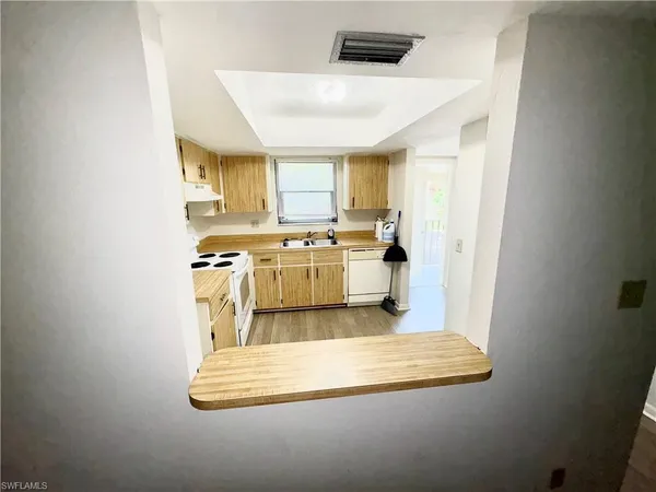 a kitchen with a stove a sink and a microwave