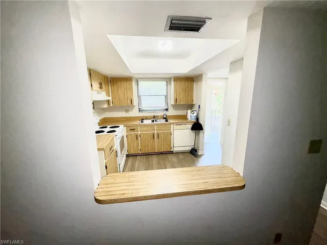 a kitchen with a stove a sink and a microwave