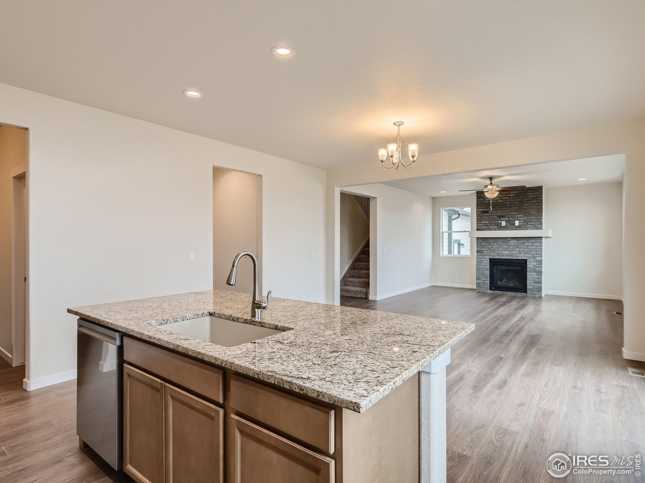 2538 Doe Rdg Way Johnstown, CO 80534 - Photo 11 of 28 a kitchen with sink cabinets and fireplace