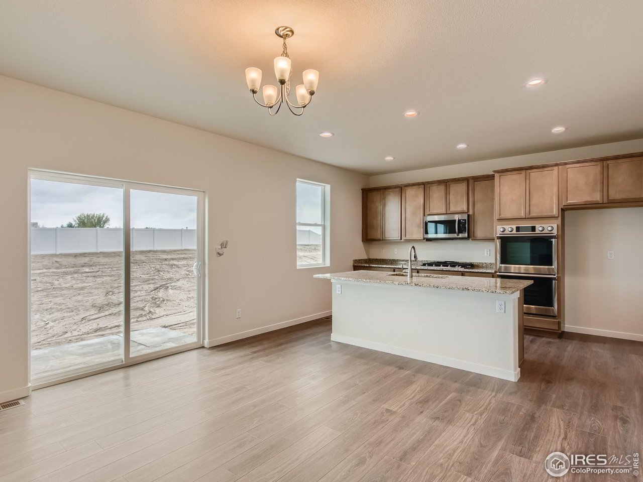 2538 Doe Rdg Way Johnstown, CO 80534 - Photo 13 of 28 a kitchen with stainless steel appliances granite countertop a refrigerator and a stove top oven